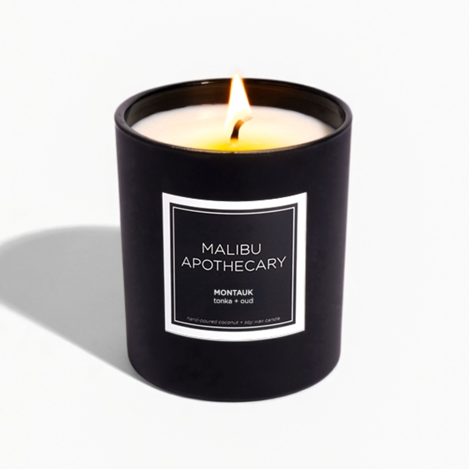 Malibu Apothecary Montauk candle in a matte black jar with coconut-soy wax and warm coastal wood fragrance inspired by the Hamptons.